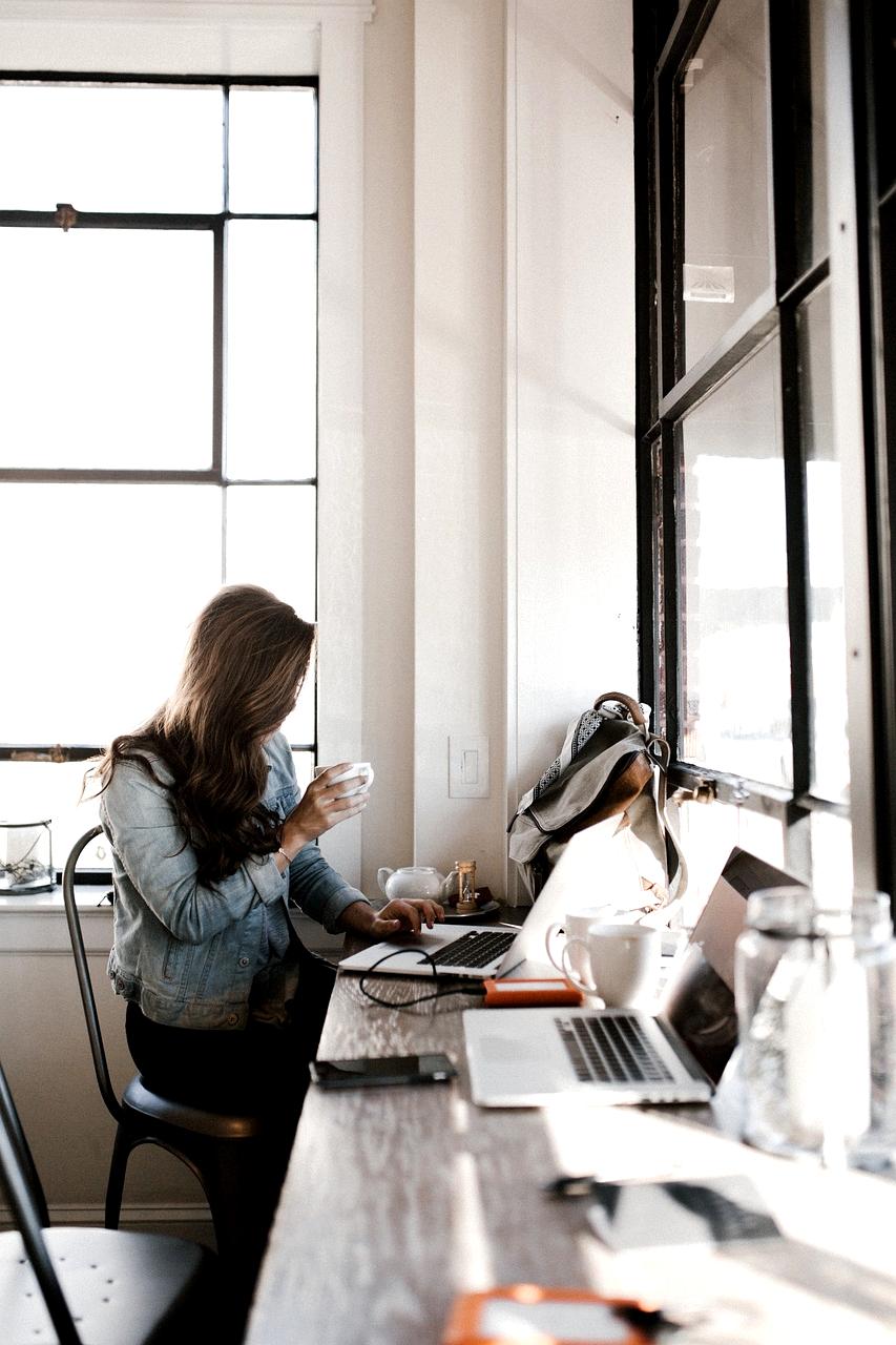 Office desk with computer, phone, and notebook